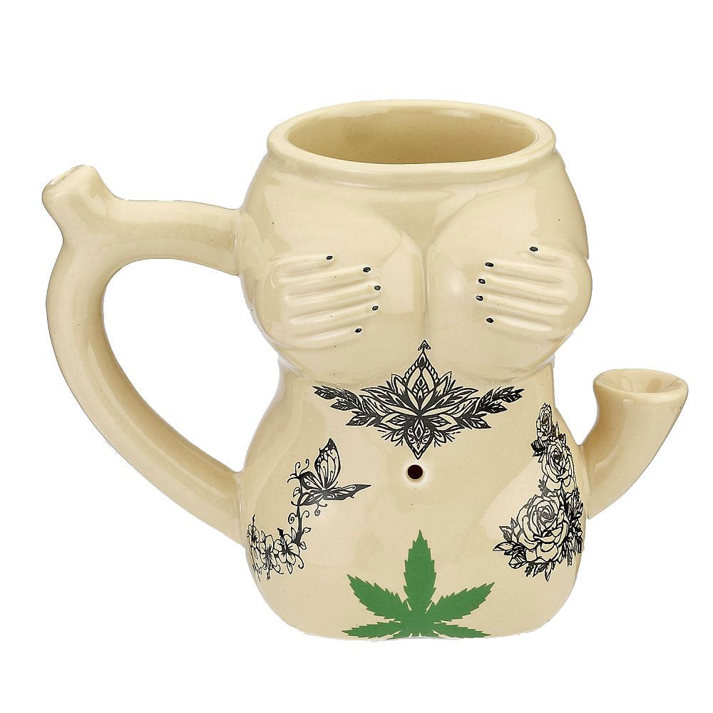 This trendy novelty mug is made of ceramic and holds around 10oz. It is shaped like a female body with hands covering her breasts. There are 3 beautiful tattoos on the front and angel wings on her back. Attached to the side of the body is a pipe where you can pack your tobacco and light it. The smoke filters up the hollow handle to the mouthpiece on the top, allowing you to enjoy a smoke with your morning or evening coffee.